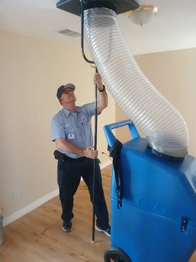 Furnace Tune-Up technician using HEPA equipment in Camas